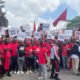 To demand improved living conditions, hundreds of Ghanaians gathered to the streets of Accra on Saturday morning. The demonstrators, who are holding signs and wearing red and black clothing, demand that the country's existing leaders step down.